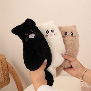 Detailed close-up of three plush cat pencil cases in black, white, and brown with soft fur