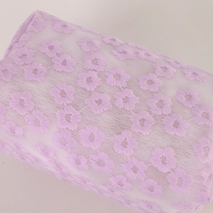 Detail of lavender mesh makeup bag featuring delicate floral 3D embroidery textures