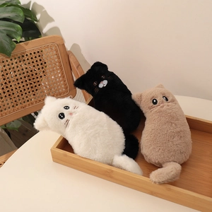 Detailed view of three soft plush cat-shaped pouches in white, black and khaki colors