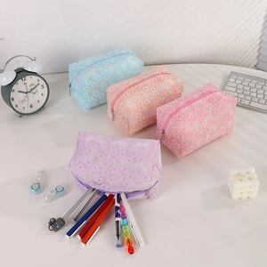 Macro detail of four pastel mesh bags featuring 3D floral lace embroidery and metal zipper