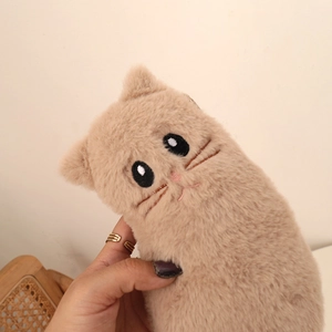 Close-up of soft plush cat pencil case with detailed embroidery and fluffy texture