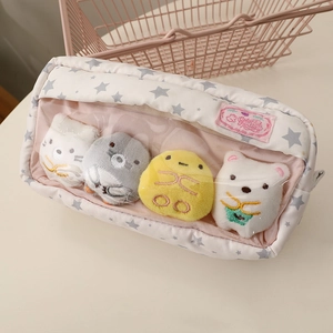 Detail of pink star print pencil case with clear window and plush charms