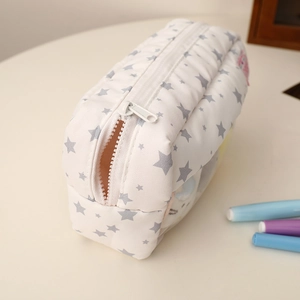 Detail view of a quilted pencil case with star patterns and a side transparent PVC window
