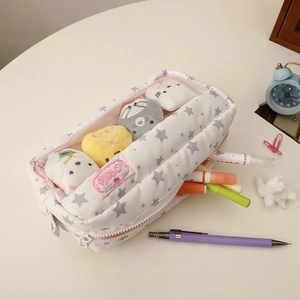 Top view of a high-capacity canvas pencil case with star patterns and stationery items