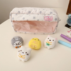 Detail of white floral pencil case with transparent window and cute plush mascots