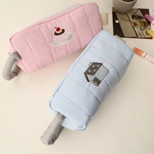 Detailed view of quilted cotton pencil cases with cute star and dessert embroidery details