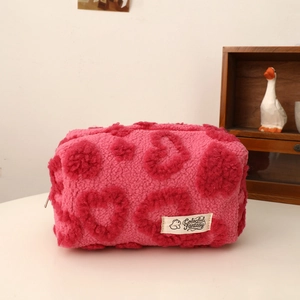 Detailed close-up of pink and red plush heart makeup bag with Colorful Fantasy label
