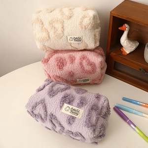 Detailed plush heart pattern storage pouches in cream, pink and purple velvet