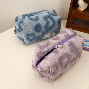 Detailed view of plush heart cosmetic bags with soft faux fur and metal zipper closure