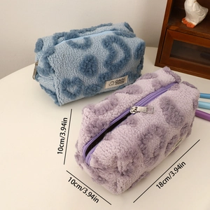 Detail of plush heart-patterned makeup bags in blue and purple with soft lamb wool texture