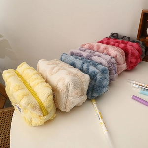 Detailed view of colorful plush makeup bags with heart patterns and zipper closure