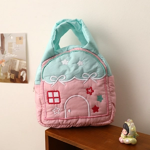 Quilted cartoon house handbag with embroidery for cosmetics and storage on wooden shelf
