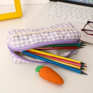 Detail of purple plaid pencil case with quilted texture and decorative white lace trim