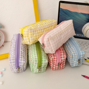 Set of 6 colorful plaid fabric pencil cases with lace trim and quilted design on desk