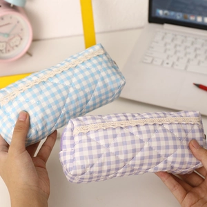 Detailed view of quilted plaid pencil cases with lace trim in blue and purple styles