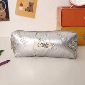 Detail of silver quilted butterfly pencil case with Colorful Fantasy label on desk
