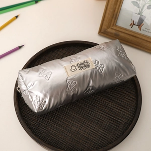 Silver quilted bow pencil case with metallic finish and Colorful Fantasy woven label