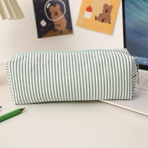 Macro detail of seersucker pencil case with green striped fabric and metal zipper