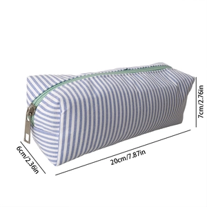 Detail view of blue striped seersucker pouch showing dimensions 20cm x 6cm x 7cm