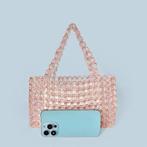 Pink crystal beaded handmade tote bag shown with a mobile phone for size scale