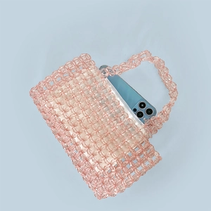 Pink transparent beaded bag detail showing interior space fitting a large smartphone