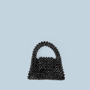 Detail of hand-woven mini tote bag made with faceted black acrylic beads on blue background