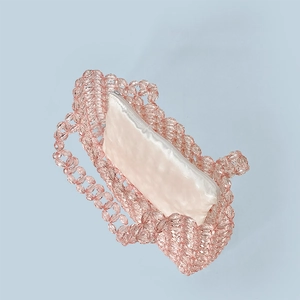 Detail of pink crystal beaded bag with cream satin zipper pouch and hollow weave design