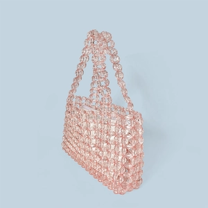 Detail of pink crystal beaded handbag with intricate handmade geometric woven texture