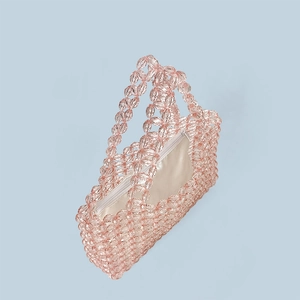 Detailed view of pink crystal beads, zipper closure, and satin lining of the handmade bag