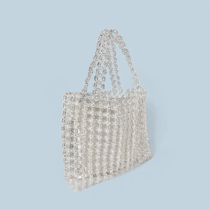 Detail view of handmade white beaded tote bag showing intricate floral weave texture