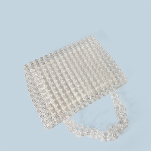 Close-up of a handmade transparent acrylic beaded handbag with woven texture