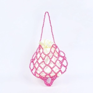 Close-up of pink beaded crochet bag with off-white satin drawstring lining detail