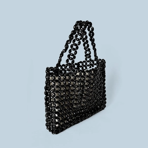 Detailed view of handmade black acrylic bead weave and faceted texture on large tote bag