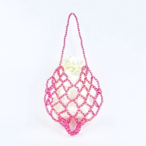 Detailed view of pink beaded crochet bag with cream satin drawstring inner pouch