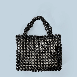 Detail of hand-woven black acrylic beads on a stylish square tote bag with integrated handle