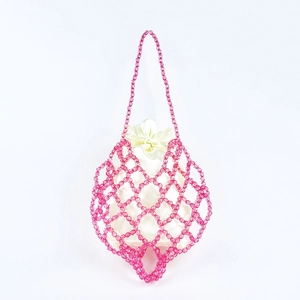 Close-up of pink beaded net bag featuring a white satin drawstring lining and handmade pearls
