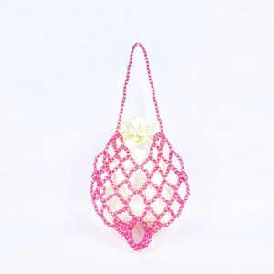 Detail of pink beaded woven mesh bag featuring a cream drawstring satin inner pouch