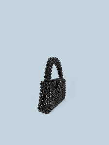 Mini black acrylic beaded handbag featuring a geometric woven design and top handle
