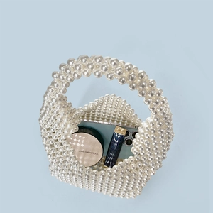 Mini handmade pearl Boston bag showing capacity for phone, lipstick and cushion foundation