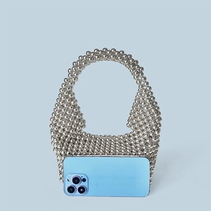 Mini silver beaded pillow bag with top handle and smartphone for size reference