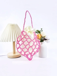 Pink beaded woven handbag with an ivory satin drawstring pouch and elegant diamond pattern