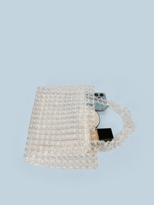 Handmade clear acrylic beaded tote bag showing storage capacity for phone and makeup