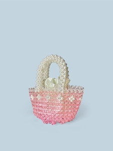 Detail of pink crystal beads and satin drawstring liner in a handmade woven bag