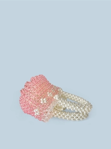 Close-up of pink crystal beads and white faux pearl flowers on handmade bucket bag