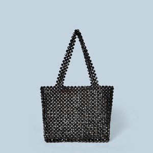 Front view of a handmade shiny black beaded tote bag featuring minimalist top handles