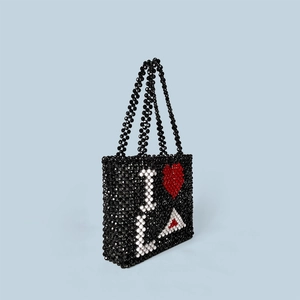 Close-up of handmade beaded tote bag featuring I Heart LA heart pattern and woven details