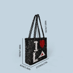 Detail shot of beaded handbag with dimensions and white letter L red heart pattern