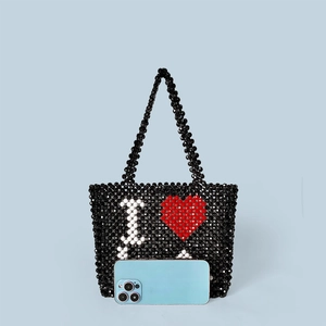 Macro shot of handmade beaded tote featuring a red heart and white I LOVE U pattern