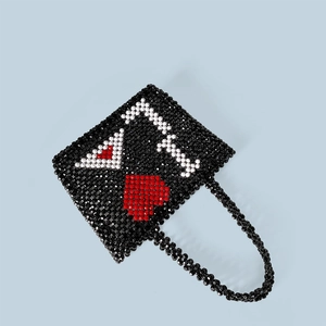 Detail of handmade beaded handbag showing intricate Ace of Hearts poker card pattern