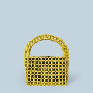 Detail showing handwoven yellow wooden beads and black fabric lining of the tote bag